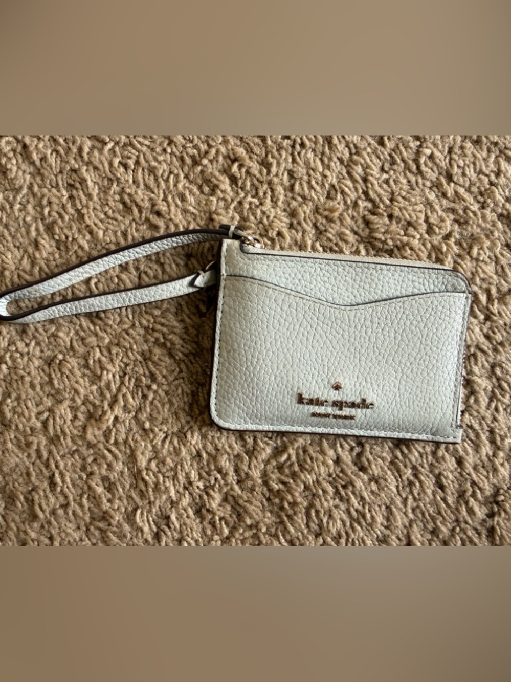 kate spade pebble leather light blue wristlet with gold logo